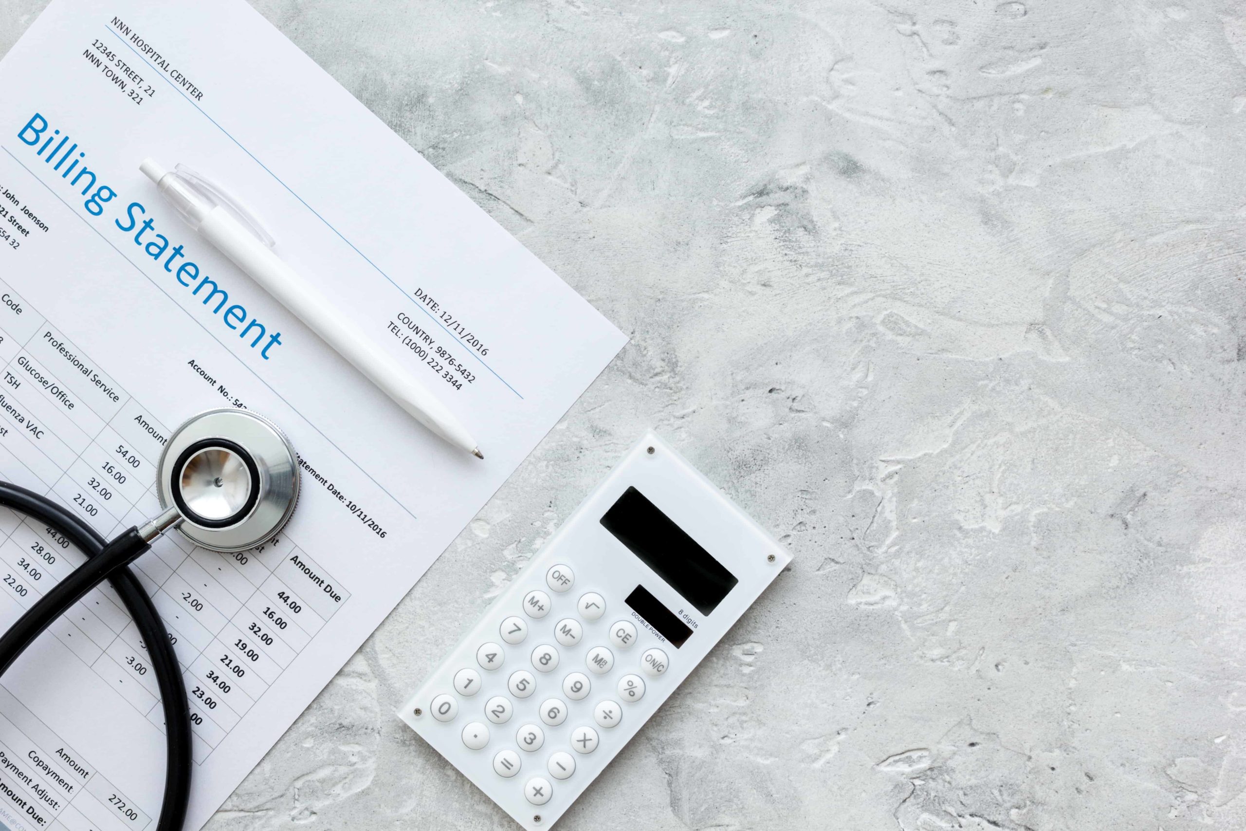 calculator and a stethoscope on top of a medical bill show the importance of cost containment in healthcare.